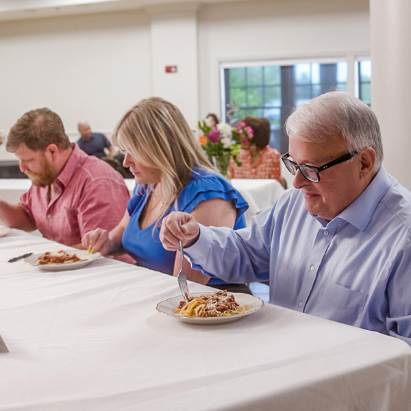 Older woman presenting her dish